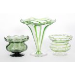 An early 20th Century Stuart & Sons glass vase of footed trumpet form with applied green wrythen