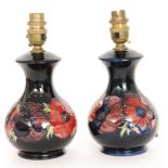 A pair of Moorcroft Pottery lamp bases decorated in the Anemone pattern with tubelined flowers