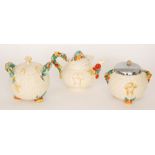 Three pieces of 1930s Clarice Cliff comprising a teapot and two biscuit barrels in the Celtic