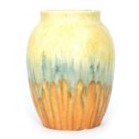 Ruskin Pottery - A crystalline glaze barrel vase decorated in a streaked yellow to blue to orange,