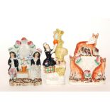 Three 19th Century Staffordshire flat back figures comprising two with painted clock faces,