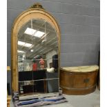 A 1930s gilt framed pier mirror, the shaped glass plate above a demi-lune onyx cupboard base,