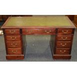 An early 20th Century mahogany twin pedestal desk fitted with nine drawers around the kneehole,