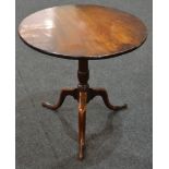 A 19th Century mahogany snap top supper table of circular form,