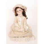 A Max Handwerck German bisque head doll with open close eyes and mouth and jointed composition body