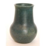 A Ruskin Pottery vase of globe and shaft form decorated in a dark blue mottled glaze,