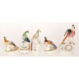 Five assorted 19th Century Staffordshire pen stands each formed as a brightly coloured bird perched