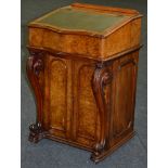 A Victorian figured walnut Davenport with fold over action to the top,