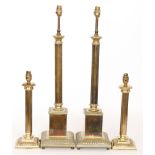 A pair of reproduction brass table lamps of reeded column form with stepped square bases,