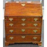 A George III mahogany bureau with fitted interior enclosed by a plain fall over drawers on bracket