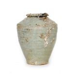 A Chinese storage jar decorated in a pale celadon glaze,