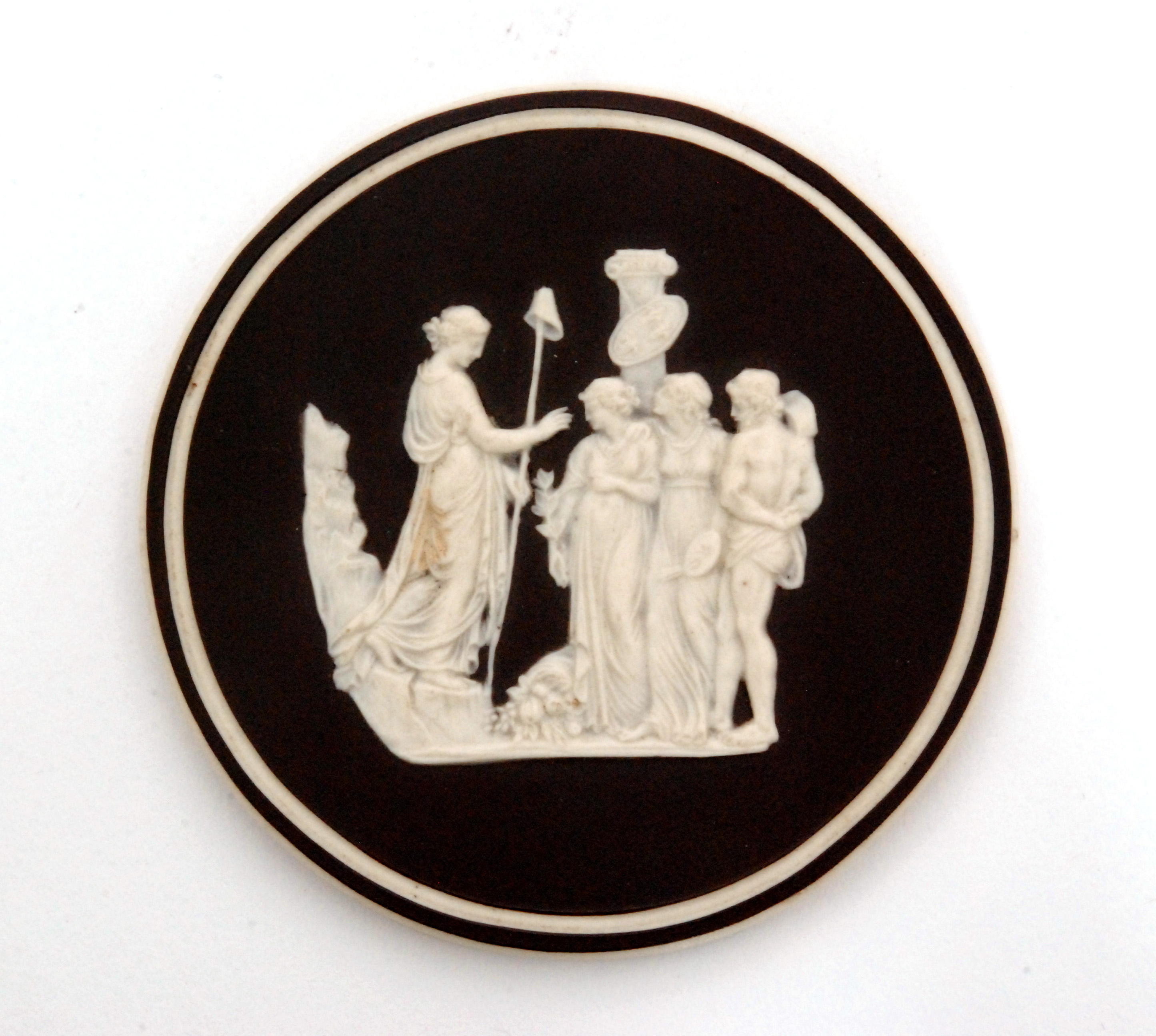 A late 18th Century basalt medallion with relief applied scene in white depicting Peace,