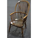 An early 20th Century ash and elm seat Windsor elbow chair on turned front legs, stamped J.W. Webb.