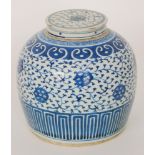 A Chinese blue and white ginger jar and cover decorated with flowers and foliage against a karakusa