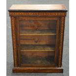 A Victorian inlaid walnut pier cabinet, the interior enclosed by a glazed door on a plinth base,