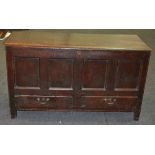 An 18th Century oak mule chest, the moulded edge top over a panelled two drawer front on stiles,