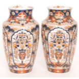 A pair of large late 19th Century Japanese Imari vases each decorated with cartouche panels against