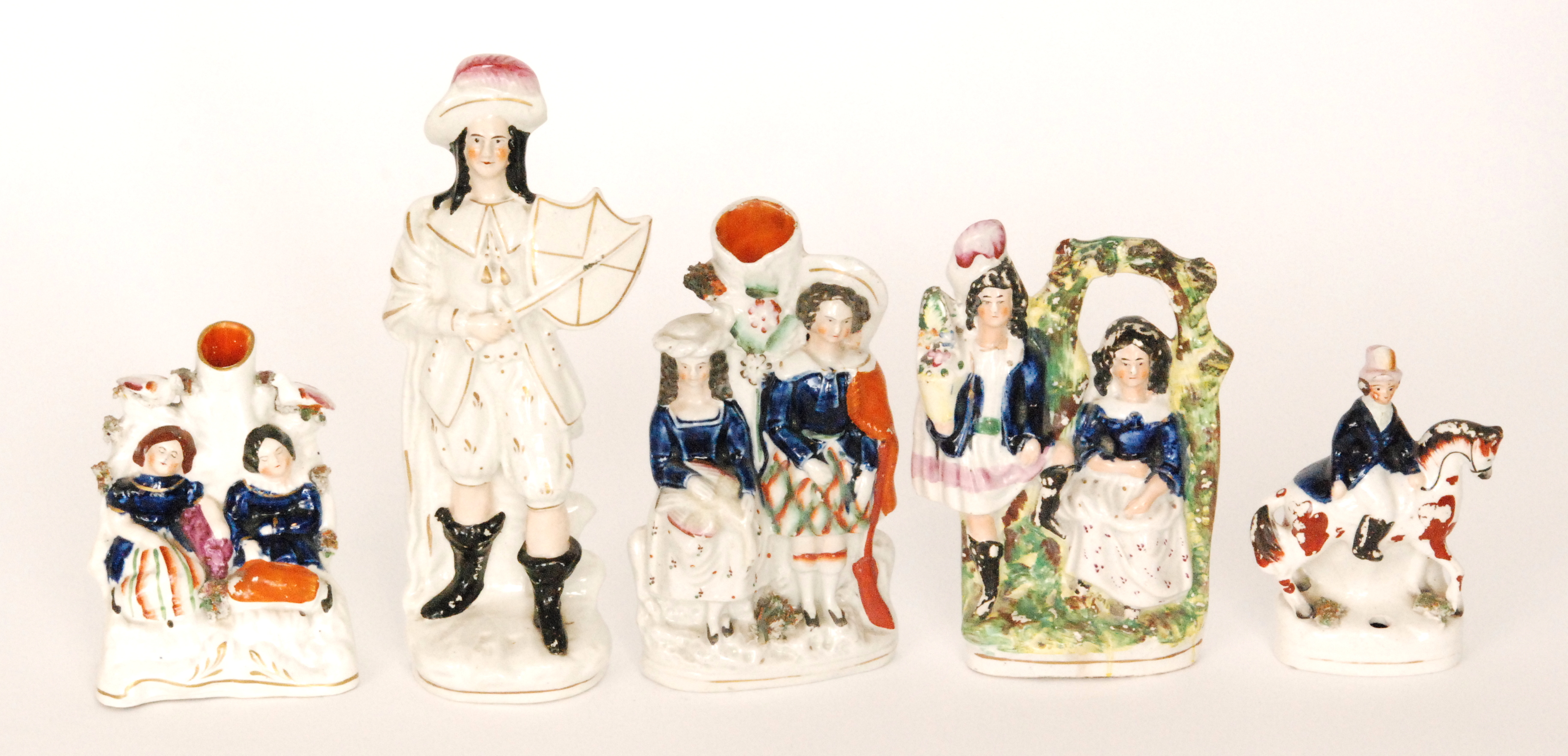 Five assorted 19th Century Staffordshire flat back figures to include a spill vase with the Royal