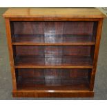 A Victorian rosewood veneered open fronted bookcase with a plinth base, height 103cm,