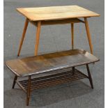 An Ercol elm and beech dining table of rounded rectangular section with drop leaves and splayed