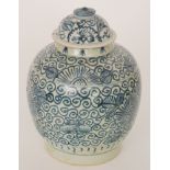 A Chinese ginger jar and cover decorated with small flower heads against a patterned scroll ground