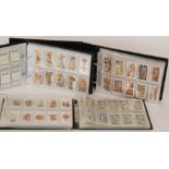 A collection of cigarette cards contained in four albums to include Players, Wills,