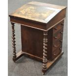 A 19th Century rosewood Davenport with fitted interior and four drawers to the side,