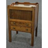 A George III mahogany tray top bedside commode with louvred cupboard door above two drawers on