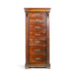 A late Victorian figured walnut Wellington chest of seven graduated drawers,