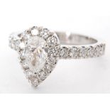 A hallmarked platinum diamond ring pear cut, claw set central stone, weight 0.