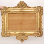 A 19th Century gilt picture frame with 'C' scroll pediment above a sconce bracket,