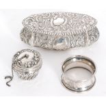 A hallmarked silver oval trinket box with embossed foliate decoration to whole, length 11cm,