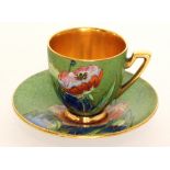 A 1930s Carlton Ware Art Deco Melon shape coffee cup and saucer decorated in the Iceland Poppy