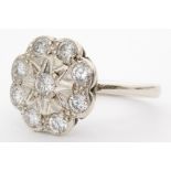 A 9ct hallmarked white gold diamond daisy cluster ring eight brilliant cut stones illusion set to a