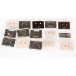 Fifteen pairs of carded 9ct single stone set earrings to include butterfly and screw fitting