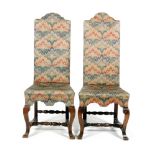 A set of four 20th Century Carolean style walnut dining chairs with arched shaped tapestry backs