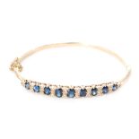 A 1960s hallmarked 9ct sapphire and diamond hinged bangle,