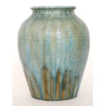 A large Ruskin Pottery vase of bulbous form decorated in a streaked tonal blue glaze with patches