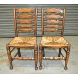 A set of six 20th Century Northern Counties oak ladder back dining chairs with rush seats,