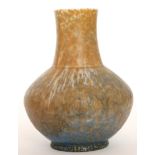 A Ruskin Pottery vase of angular form with a chimney neck decorated in a streaked and mottled blue