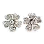A pair of 18ct white gold diamond set flower clip earrings, modelled with five heart shaped petals,