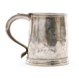 An early 18th Century hallmarked silver mug of plain form with reeded borders and plain scroll
