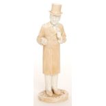 A late 19th Century figure of a gentleman dressed in a long over coat and top hat,
