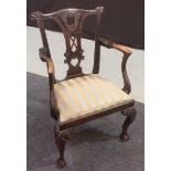 A Chippendale style mahogany carver chair with scrolled capitals and a pierced vase splat above the