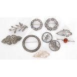 Ten assorted silver brooches to include marcasite, stone set and other examples,