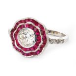 A modern 18ct white gold ruby and diamond flower head ring,
