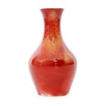 A 1910s William Moorcroft 'lost shape 372' vase of mallet form glazed in a ruby and ochre lustre,
