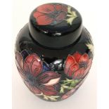 A boxed Moorcroft ginger jar and cover decorated in the Anemone Blue pattern,