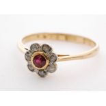 An early 20th Century ruby and diamond daisy cluster ring,