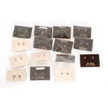 Fifteen pairs of carded 9ct single stone set earrings to include butterfly and screw fitting